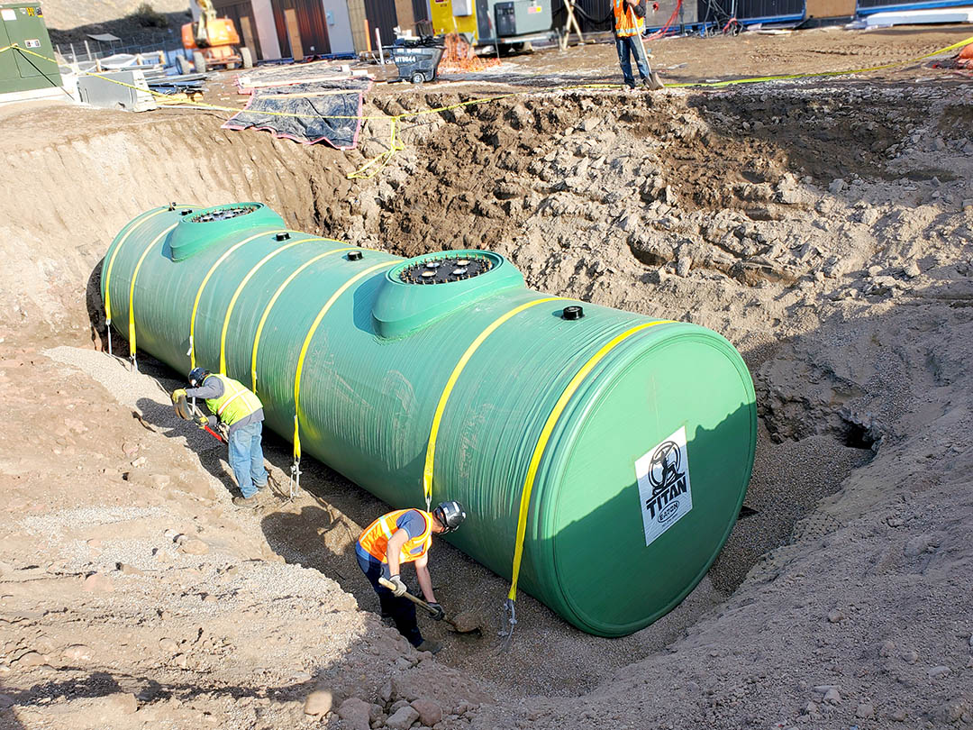 Eaton Sales & Service LLC construction workers burying a TITAN underground steel fuel storage tank.